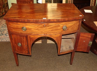 Lot 597 - A George III mahogany, boxwood and ebony strung bowfront sideboard, early 19th century, with a long