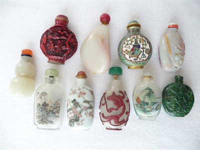 Lot 213 - A Peking Glass Red Overlay Snuff Bottle, late 19th/20th century, carved with mythical beasts...