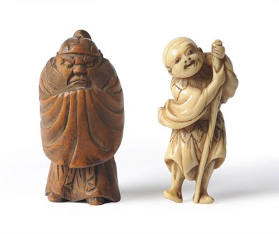 Lot 220 - A Japanese Carved Ivory Netsuke as a Peasant, 19th century, the smiling man dressed in an...