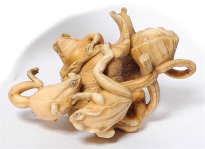 Lot 231 - A Japanese Carved Ivory Frog Okimono, late Meiji period (1868-1912), as three frogs wrestling...