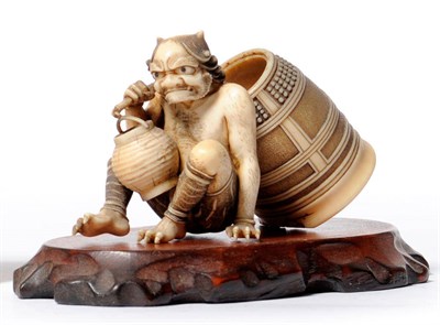 Lot 233 - A Japanese Carved Elephant Ivory Okimono of an Oni, Meiji period (1868-1912), the seated oni...