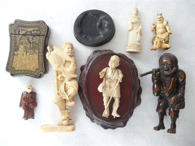 Lot 239 - A Japanese Carved Ivory Figure, late Meiji period (1868-1912), as a wandering monk holding a...