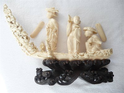 Lot 240 - A Chinese Marine Ivory Carved Boat Group, circa 1920, the shallow vessel carrying two women...