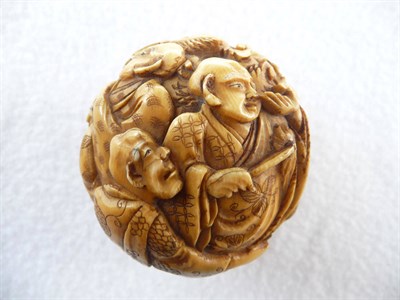 Lot 248 - A Japanese Carved Ivory Ball, Meiji period (1868-1912), decorated with a number of figures and...