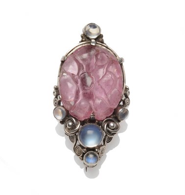 Lot 257 - An Arts and Crafts Brooch, an oval carved rose quartz depicting a floral motif, in a scrolling...