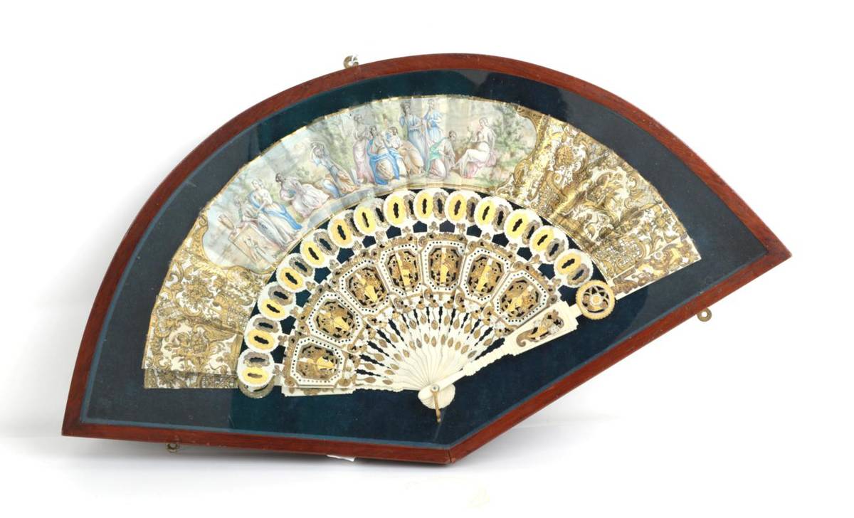Lot 2016 - A Mid-19th Century Ivory Fan, the carved and well-shaped monture gilded in two shades of gold....