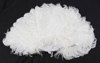 Lot 2032 - A Circa 1900 White Ostrich Feather Fan, with white Mother-of-pearl monture, gilded and...