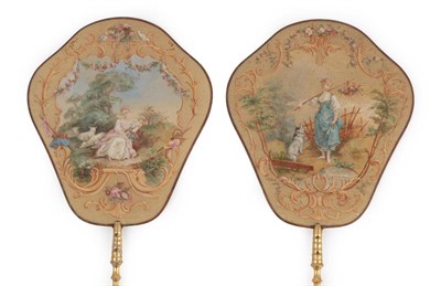 Lot 2061 - An Elegant Boxed Pair of 19th Century French Silk Face Screens, mounted on gilded turned wood...
