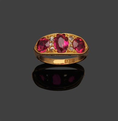 Lot 270 - A Late 19th Century Synthetic Ruby and Diamond Ring, an oval cut ruby flanked by two round cut...