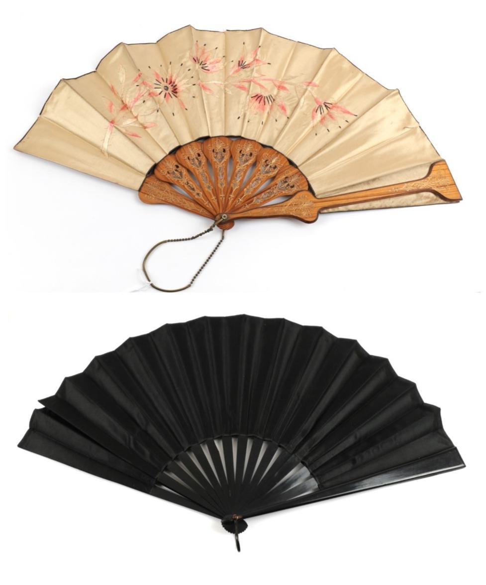 Lot 2075 - The 1890's: Two Large Late 19th Century Fans, one embroidered on dark cream silk, a spray of...
