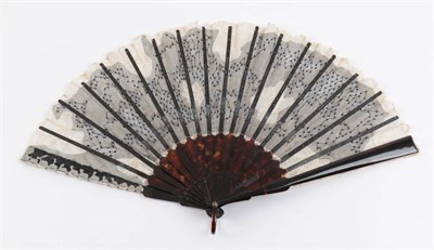 Lot 2125 - A Tortoiseshell Fan, circa 1900, mounted with a leaf of black net, applied white Brussels...