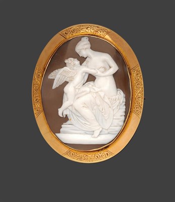 Lot 277 - A Shell Cameo Brooch, the oval cameo depicts a classical scene, within a ropework and polished...