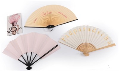 Lot 2168 - C'est La Vie!: Three Modern Advertising Fans, to include a paper fan with hard black metal...