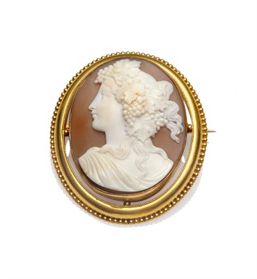 Lot 282 - A Shell Cameo Brooch, the oval cameo depicts the profile of a classical maiden, in a ropework...