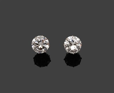 Lot 300 - A Pair of Diamond Solitaire Stud Earrings, the round brilliant cut diamonds held in white claw...