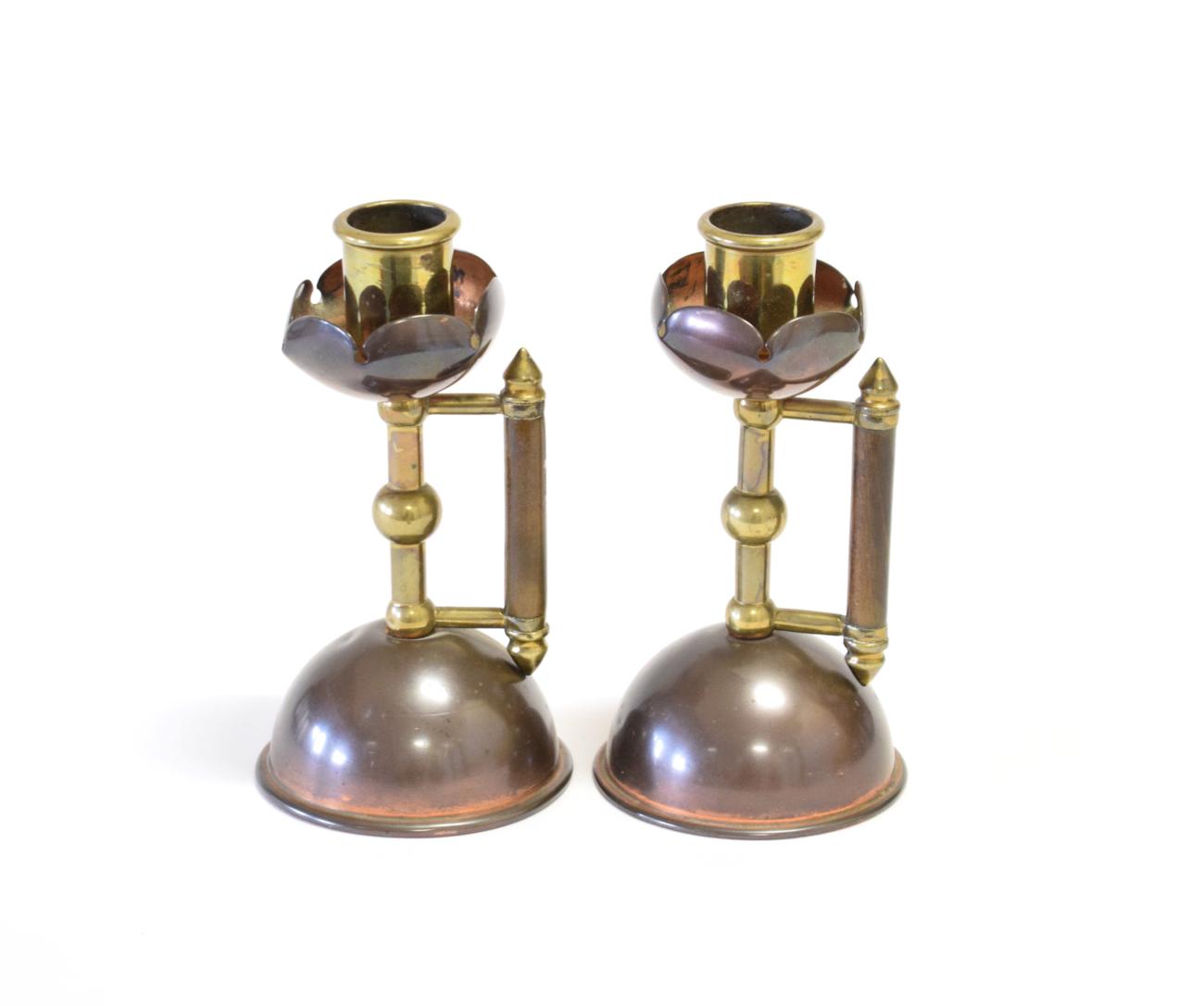 Lot 3564 - A Pair of  Benham & Froud Copper and Brass Candlesticks, attributed to Christopher Dresser, stained