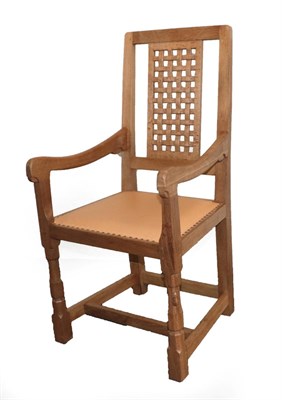 Lot 3603 - Mouseman: A Robert Thompson of Kilburn English Oak Coxwold Lattice Back Arm Chair, with curved...