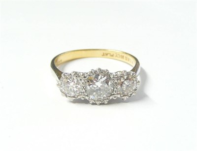 Lot 308 - A Diamond Three Stone Ring, the graduated round brilliant cut diamonds in white claw settings...