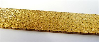 Lot 310 - An 18 Carat Gold Bracelet, the broad textured bracelet measures 18.6cm in length and 1.8cm in width