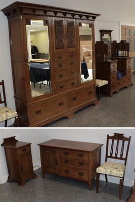Lot 3642 - An Arts & Crafts Oak Six Piece Bedroom Suite, comprising a Wardrobe, the cornice above two mirrored