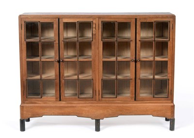 Lot 3649 - Gordon Russell (1892-1980): A Walnut and Ebony Bookcase, with four glazed doors enclosing six...