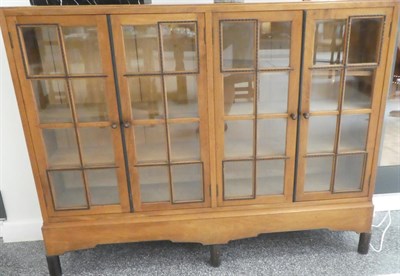 Lot 3649 - Gordon Russell (1892-1980): A Walnut and Ebony Bookcase, with four glazed doors enclosing six...