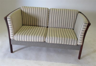 Lot 3653 - Stouby: A Danish Stained Beech Two-Seater Sofa, covered in striped cream fabric and grey cloth back