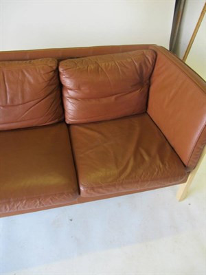 Lot 3654 - Stouby: A Beech Framed Three-Seater Sofa, upholstered in brown leather, with eight removable...