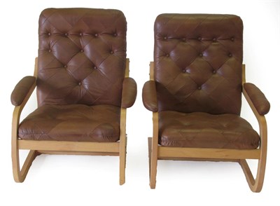 Lot 3668 - A Pair of Danish Design Beech and Bentwood Lounge Chairs, upholstered in buttoned brown...