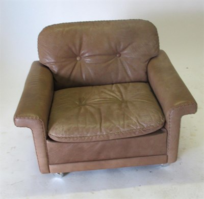 Lot 3669 - A 1970's Danish Armchair, covered in light brown, buttoned and stitched leather, with square...