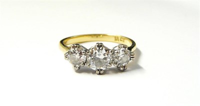 Lot 326 - A Diamond Three Stone Ring, the graduated round brilliant cut diamonds in white claw settings, to a