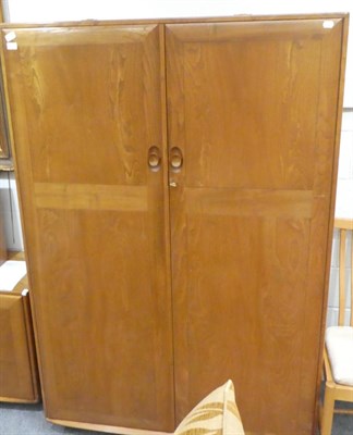 Lot 1000 - An Ercol Windsor Pattern Double Door Wardrobe, the interior with hanging space, 121cm by 53cm...