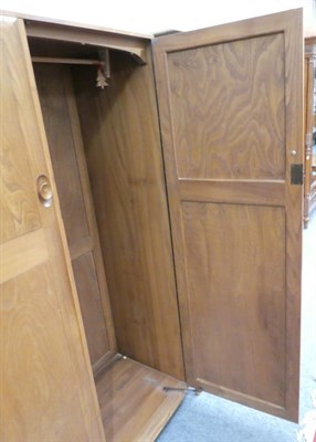 Lot 1000 - An Ercol Windsor Pattern Double Door Wardrobe, the interior with hanging space, 121cm by 53cm...