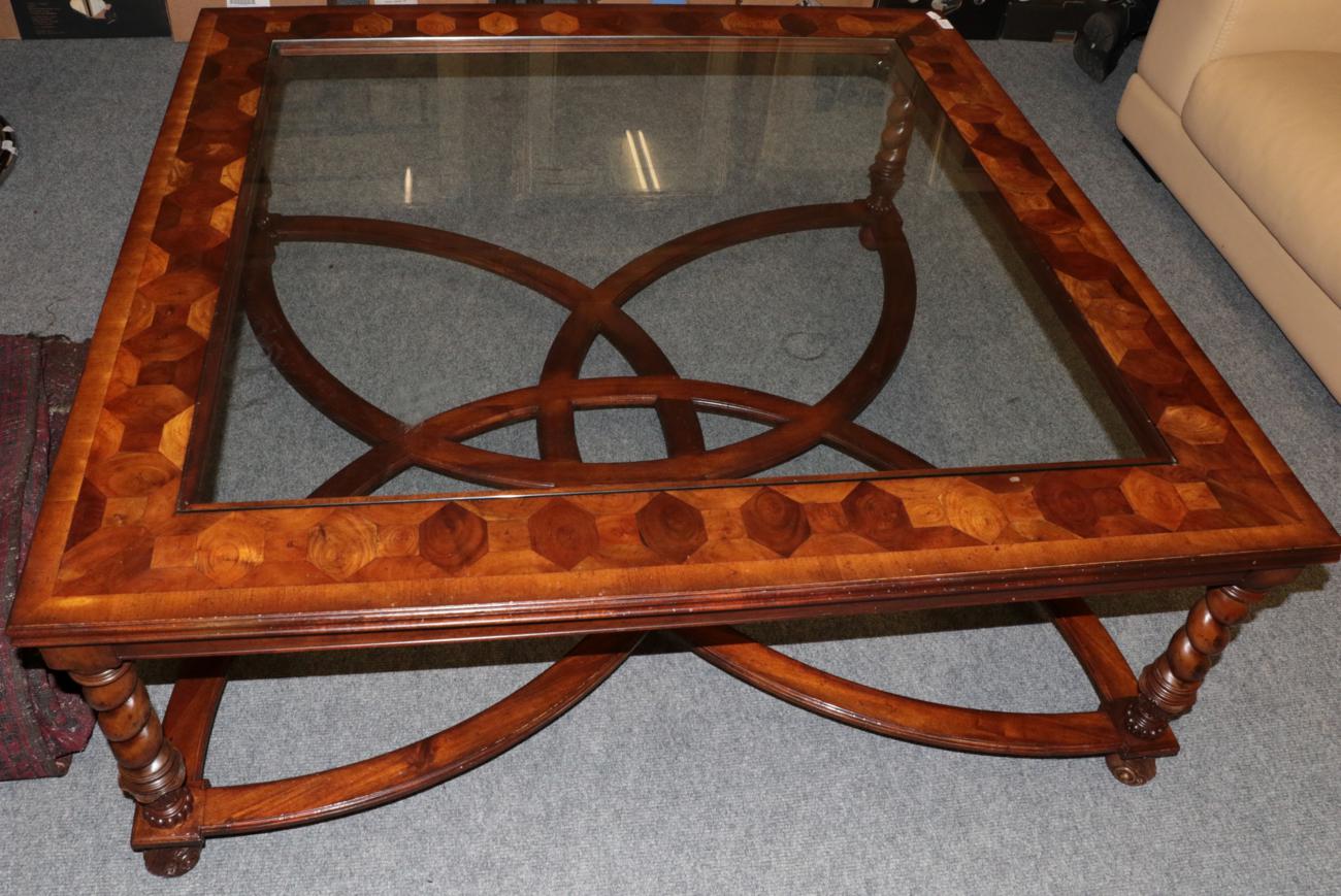 Lot 1012 - A Walnut and Oyster Veneered Style Glass Top Coffee Table, modern, of square with spiral turned...