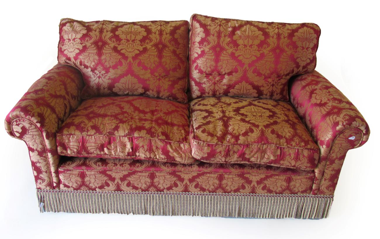 Lot 1016 - A Good Quality Two-Seater Feather-Filled Sofa, modern, covered in crimson, red and gold fabric,...
