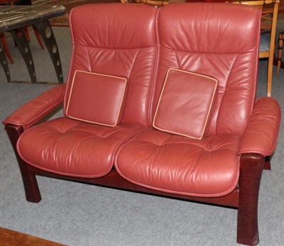 Lot 1030 - An Ekornes Stressless Two-Seater Sofa, modern, the stained beech frame and reclining seats with...