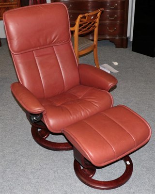 Lot 1031 - An Ekornes Stressless Swivel Armchair, modern, the stained beech frame with padded back support and