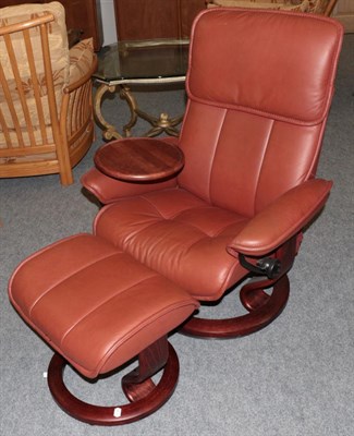 Lot 1032 - An Ekornes Stressless Swivel Armchair, modern, the stained beech frame with padded back support and