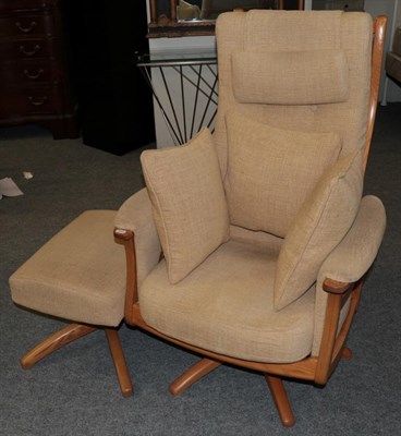 Lot 1033 - An Ercol Ash Framed Swivel Armchair, circa 2005, design no.1081H, upholstered in cream fabric,...