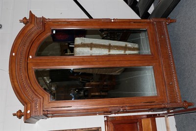 Lot 1035 - And So To Bed: A Walnut Effect Eclectic Wardrobe with Mirror, the moulded pediment above two...