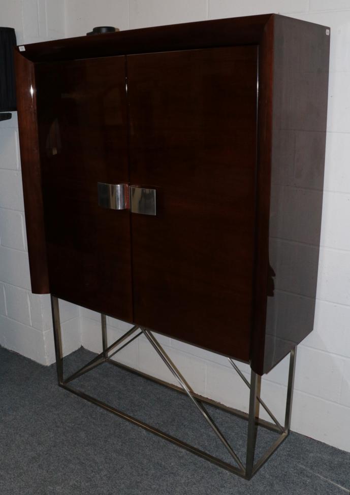 Lot 1041 - A Polished and Laminated Walnut Double Door Cabinet, modern, with two cupboard doors with...