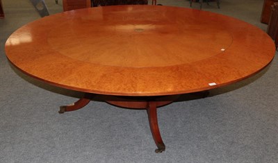 Lot 1052 - A Reproduction Burr Maple Extending Dining Table, of circular form, with five additional leaves, on