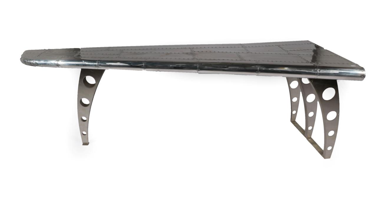 Lot 1054 - An Aviator Style Console Table, modern, in the form of a curved aeroplane wing, the polished...
