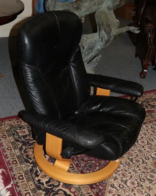 Lot 1066 - An Ekornes Stressless Lounge Reclining Armchair, in black leather, 84cm by 64cm by 96cm