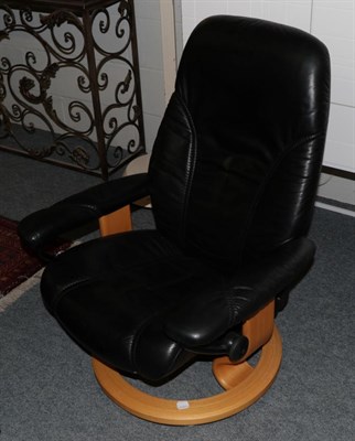 Lot 1067 - An Ekornes Stressless Reclining Lounge Armchair, in black leather, 70cm by 56cm by 96cm