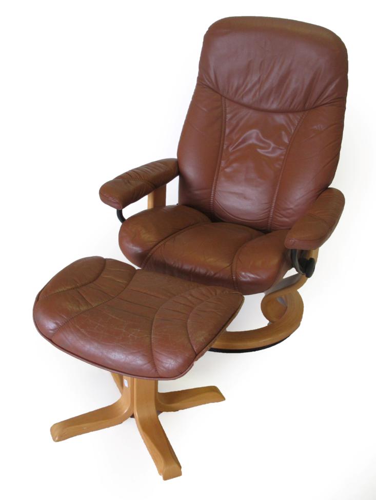 Lot 1069 - An Ekornes Stressless Swivel Lounge Chair, in tan leather,  with padded arms and beech frame,...