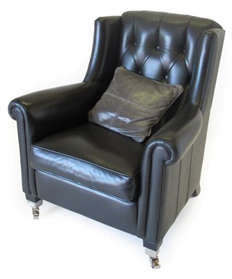 Lot 1072 - Duresta: A Black Leather Button-Back Armchair, modern, with rounded arms and squab cushion, on...