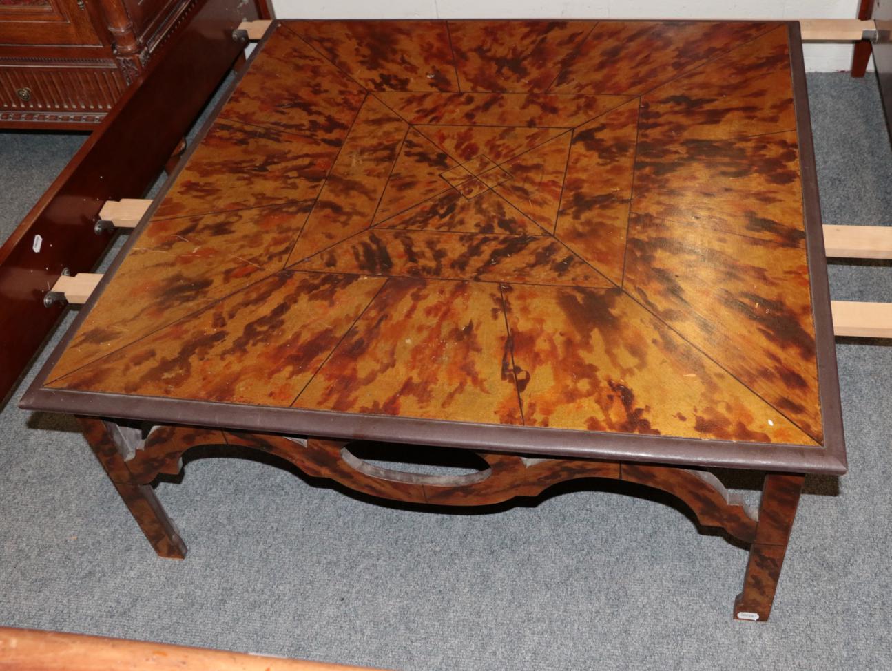 Lot 1075 - A Faux Tortoiseshell Painted Coffee Table, of square form with pierced apron, on square...