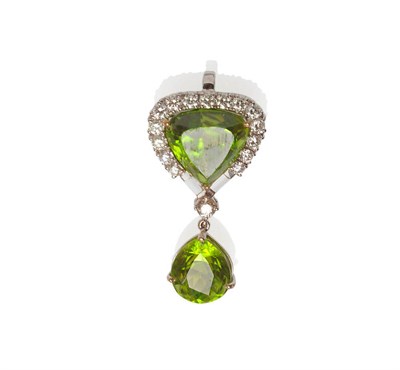 Lot 351 - An 18 Carat White Gold Peridot and Diamond Drop Pendant, a triangular peridot within a border...