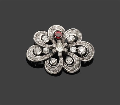 Lot 359 - A Diamond and Ruby Brooch, an oval cut diamond centres seven diamond set loops, which surround...